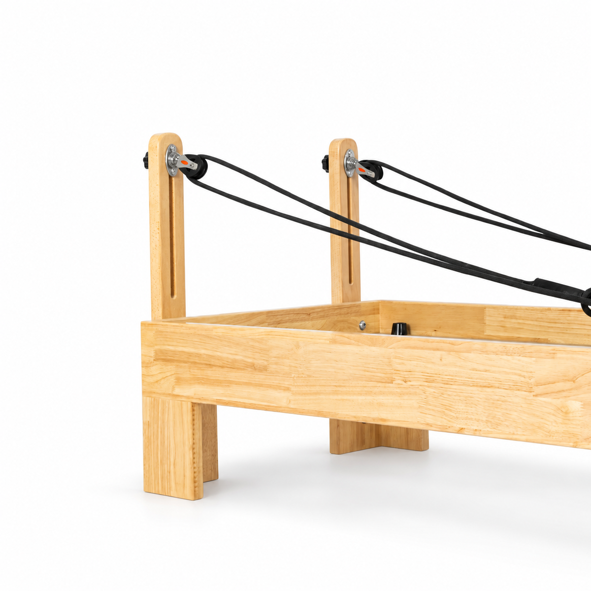 Vue arrière du Reformer Pilates montrant la structure en bois clair et les poulies