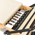 Système de ressorts et réglage de résistance du reformer Pilates studio en bois naturel - Pilates At Home
