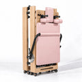 Machine Reformer Pilates pliable en bois clair avec revêtement rose, vue compacte repliée sur roulettes - Pilates At Home